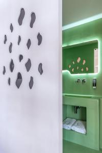 a bathroom with a wall with footprints in the wall at LOFUS Bio-Suites in Athens