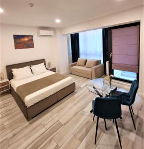 a bedroom with a large bed and a glass table at Zeita din Bel-Air, Mamaia Nord in Mamaia