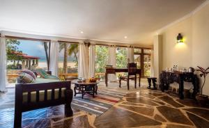 a living room with a grand piano and a table at Blue Marlin Beach Hotel in Diani Beach