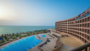 a view of the ocean from the balcony of a hotel at Grand Millennium Gizan in Jazan