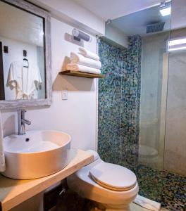 a bathroom with a sink and a toilet and a shower at Aria By LD Hotel Boutique in Pampatar