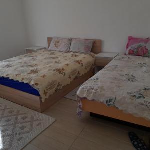 two twin beds in a room with at Къща за гости Лилия 