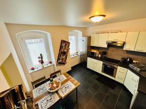 a kitchen with white cabinets and a table with a plate on it at Gemütliche Wohnung in Grünhainichen Erzgebirge in Grünhainichen