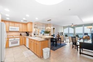 a kitchen and dining room with a view of the ocean at Portofino Island Resort & Spa Tower Two 1306 in Pensacola Beach