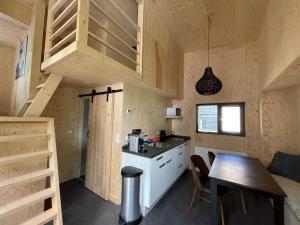 a kitchen with a sink and a counter top at Tiny House am Veluwemeer im Europarcs Bad Hoophuizen in Hulshorst