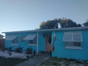 a blue house with a door and a window at Beach House in Pensacola