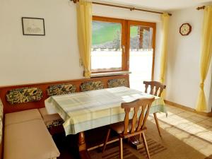 a dining room with a table and chairs and a window at Haus Früh in Telfes im Stubai