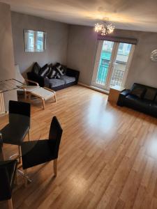 a living room with a couch and a table at No 11 3 BED SERVICED APPARTMENT TOWN CENTRE in Girvan