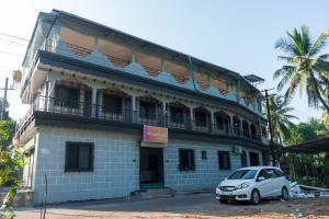 a car parked in front of a building at Anandvan Beach Resort in Alibaug