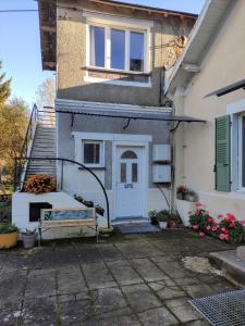 a house with a bench in front of it at Gite Les Eylauds in Pionsat