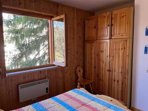 a bedroom with a bed and a window at La casa di Fantalegno in Camigliatello Silano