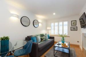 a living room with a couch and a glass table at Apartment in the heart of the city centre, live like a local in Oxford