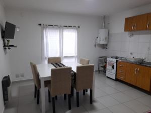 a kitchen with a table and chairs in a room at Departamento céntrico in Esperanza