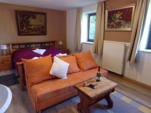 a living room with a couch and a table at Urlaubspension Die Mühle in Schöllnach