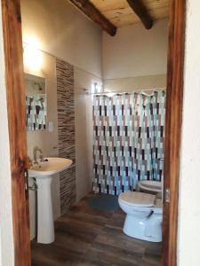 a bathroom with a toilet and a sink at Finca La Calma in San Rafael