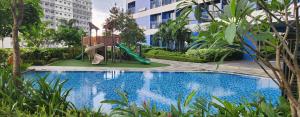 a small pool with a slide and a playground at SMDC AIR RESIDENCES in Manila