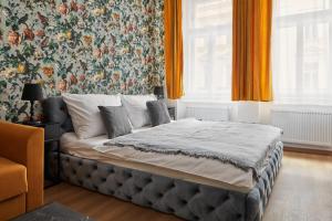 a bedroom with a bed with a floral wallpaper at Designer Studio in New Town by Prague Days in Prague