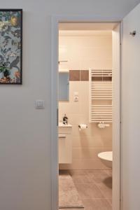 a bathroom with a toilet and a sink at Designer Studio in New Town by Prague Days in Prague