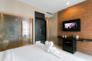 Ένα ή περισσότερα κρεβάτια σε δωμάτιο στο The House Patong