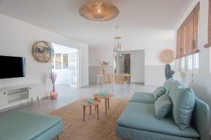 a living room with a blue couch and a table at NEW ! Cozy Casa in Oranjestad