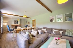 a living room with a couch and a table at The Wing at Warham in Winkleigh