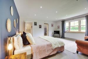 a bedroom with a large bed and a couch at The Wing at Warham in Winkleigh