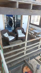 a view of a porch with chairs and a table at Mancora Apartments in Máncora