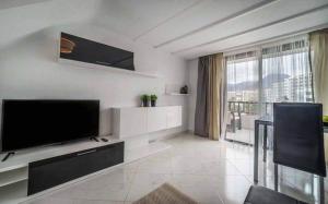 a living room with a flat screen tv on a wall at Parque Santiago 2 - Playa de Las Américas Tenerife in Arona