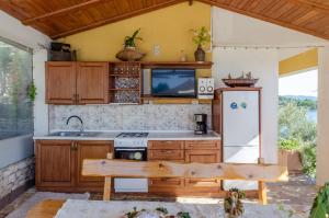 a kitchen with a refrigerator and a sink at Villa Paradise in Vela Luka