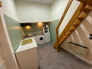 a small kitchen with a washer and dryer at Boost Your Immo Ramond Barèges PM26 in Barèges