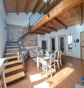 a living room with a table and a staircase at Sweet Loft (Iun P8227) in Alghero