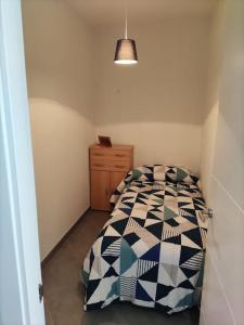 a small bedroom with a bed and a dresser at Casa Consuelo Malpica in Malpica