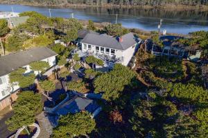 an overhead view of a house with trees and water at Loki's Kingdom in Rockaway Beach
