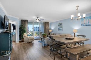 a living room and dining room with a table and chairs at Heron 507- A Wave From It All in Fort Walton Beach