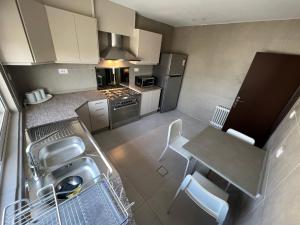 an overhead view of a kitchen with a table and chairs at Bedouin Break Condo - In the Heart of Amman in Amman +6 photos