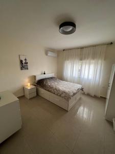 a bedroom with a bed and a lamp in it at Bedouin Break Condo - In the Heart of Amman in Amman