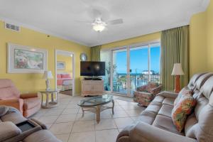 a living room with a couch and a tv at Leeward Key 401 in Destin