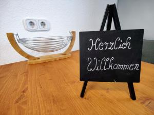 a chalkboard sign sitting on a floor next to a hammock at YourFavoriteBed 100m2 Designwohnung mit Vollausstattung in Plauen