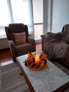 a living room with a table with a candle on it at Solete in Suances