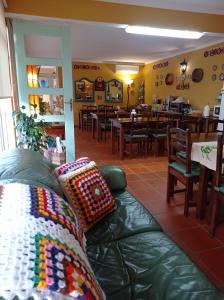 a living room with a couch in a restaurant at A Casa da Ti Laura - AL in Aveiro