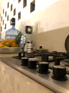 a stove top in a kitchen with a bowl of fruit at PALUM Prívate Room share bathroom in Palomino
