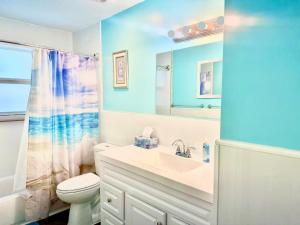 a bathroom with a sink and a toilet and a mirror at Seashell 2 in Boynton Beach +31 photos