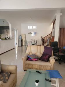 a living room with a couch and a table at Lacase Silverpalm in Pereybere