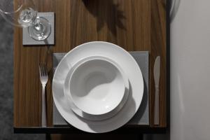 a plate on a table with a fork and a glass at City Centre Studio 1 with Kitchenette, Free Wifi and Smart TV with Netflix by Yoko Property in Middlesbrough