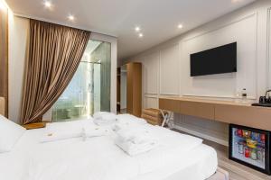מיטה או מיטות בחדר ב-Olimp Hotel