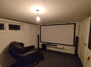 una stanza con un grande schermo in una stanza di Louisiana Rent a Espergærde