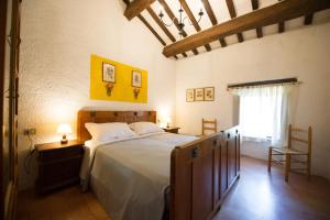 a bedroom with a large bed and a window at ABBAZIA DI VALLINGEGNO in Gubbio