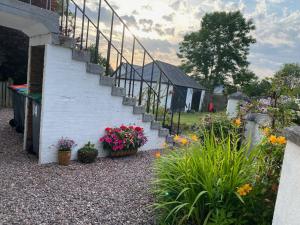 a stairway with flowers and plants in a yard at St John's Flat Spacious Accomodation in Dalry