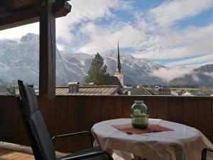 a table on a balcony with a view of a mountain at Haus Alpenglühn in Abtenau