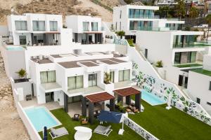 an aerial view of a white apartment building with a swimming pool at Villa Eden in Adeje